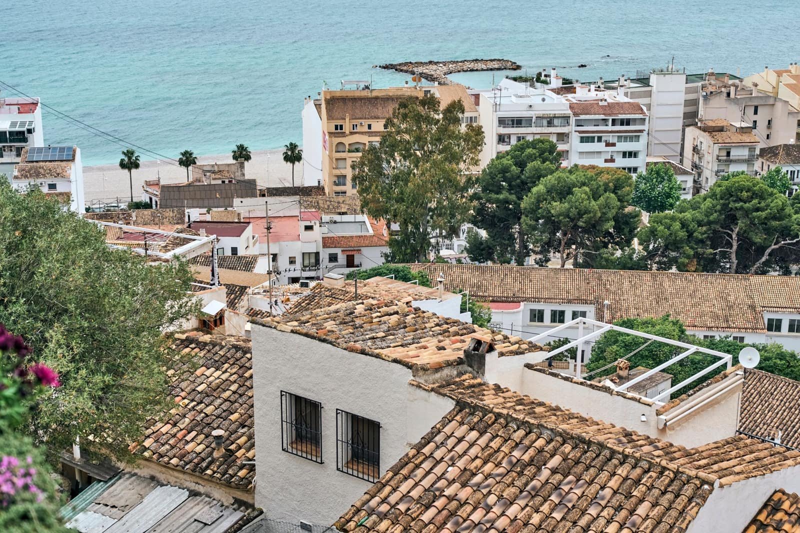 A Spanish coastal town of terracotta rooftops above the Mediterranean
